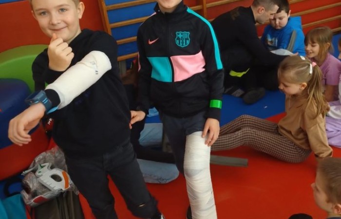 14 marca ponownie gościliśmy w swoich progach strażaków z OSP Marianka oraz JRG nr 3 w Pasłęku, którym towarzyszyły wolontariuszki z Zespółu Szkół w Pasłęku. Po ostatnim szkoleniu przedszkolaków przyszła pora na naszych pierwszoklasistów. Spotkanie było niezwykłą okazją do uwrażliwienia dzieci na to, jak ważne jest wezwanie pomocy, utrwalaliśmy numer alarmowy 112, no i oczywiście mogliśmy poćwiczyć udzielanie pierwszej pomocy, opatrywanie ran i złamań. Nie mniejszym zainteresowaniem wśród naszych uczniów cieszył się sprzęt strażacki :)
Jak widać na zdjęciach dzieci były zachwycone, a przy okazji naprawdę wiele się nauczyły.
