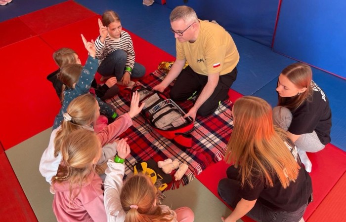 Wczoraj ponownie odwiedzili nas strażacy z OSP Marianka oraz JRG nr 3 w Pasłęku, którym towarzyszyły wolontariuszki z Zespołu Szkół w Pasłęku. Tym razem w spotkaniu uczestniczyli uczniowie klas drugich. Podczas szkolenia dzieci utrwaliły numer alarmowy 112, a także zapoznały się z całą procedurą zgłaszania wypadku i wzywania fachowej pomocy. Uczniowie dowiedzieli się co nieco na temat pracy strażaków, a także tego w jaki sposób opatruje się rany, złamania, udziela pierwszej pomocy, a co najważniejsze mieli okazję do przećwiczenia wszystkiego „na własnej skórze”. Jak widać po zdjęciach i tym razem dzieci były zachwycone. 
To była niezwykle istotna lekcja pomagająca poprzez zabawę i doświadczenia zdobywać nowe bardzo ważne informacje i umiejętności. 