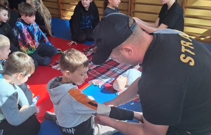 Za nami kolejne spotkanie ze strażakami z OSP Marianka, JRG 3 w Pasłęku oraz wolontariuszkami z Zespołu Szkół w Pasłęku w ramach akcji „Dzieci ratują życie”. Tym razem przyszła kolej na uczniów klas trzecich. Tradycyjnie już, nasi podopieczni mieli okazję do zgłębienia „tajników” pracy strażaków, utrwalenia numeru alarmowego, zasad postępowania podczas wzywania pomocy służb ratowniczych, a także udzielania pierwszej pomocy, opatrywania ran i złamań. Nie trzeba nikogo przekonywać, jak ważne jest przekazywanie wiedzy i kształtowanie praktycznych umiejętności w tym zakresie, na każdym etapie edukacji. 
Dzięki naszym wspaniałym gościom kształcimy małych ekspertów, którzy z pewnością będą wiedzieli jak zachować się w sytuacji zagrożenia.
