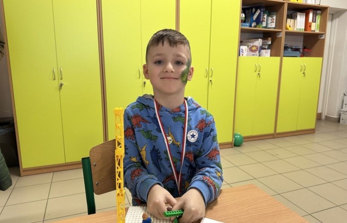 26 lutego w naszej szkole odbył się wyjątkowy DZIEŃ OTWARTY, podczas którego mieliśmy przyjemność gościć przedszkolaków, przyszłych uczniów oraz ich rodziców. Była to doskonała okazja, aby poczuć atmosferę naszej szkoły, poznać jej ofertę edukacyjną i odkryć to, co czyni ją miejscem pełnym pasji, wiedzy i radości.
Zwiedzanie naszej placówki obejmowało sale przedmiotowe, bibliotekę, stołówkę, świetlicę oraz małą salę gimnastyczną, gdzie można było na własnej skórze poczuć rytm codziennego życia naszej szkolnej społeczności.
Na odwiedzających czekało mnóstwo niespodzianek! Zachętą do działania były pieczątki, które najmłodsi otrzymywali w nagrodę za wykonanie przeróżnych zadań. W sali gimnastycznej na uczestników czekały ekscytujące konkurencje sprawnościowe, a w pracowni kulinarnej – pachnące i chrupiące gofry własnej roboty. Młodzi odkrywcy mieli okazję badać świat przez mikroskop, eksperymentować z interaktywnymi robotami Photon oraz brać udział w zajęciach z robotyki. Z kolei miłośnicy sztuki mogli tworzyć piękne dzieła na warsztatach plastycznych i origami, a najmłodsi cieszyli się malowaniem twarzy.
Nie zabrakło także wyzwań dla bystrego umysłu! Gry i zabawy językowe, rebusy oraz polonistyczne łamigłówki rozbudzały wyobraźnię i rozwijały umiejętności językowe. Wesoła „Gimnastyka buzi i języka” sprawiła, że ćwiczenie dykcji stało się czystą przyjemnością. Ogromnym zainteresowaniem cieszyły się również gry planszowe, które dostarczyły mnóstwa radości i emocjonującej rywalizacji. Dodatkowo, zabawy z chustą Klanza okazały się świetnym sposobem na integrację i wspólną zabawę pełną śmiechu.
Aktywne zwiedzanie stało się więc okazją do rozwijania ciekawości świata, nabywania nowych umiejętności, pobudzania w najmłodszych kreatywności oraz odczuwania satysfakcji z osiągniętego sukcesu.