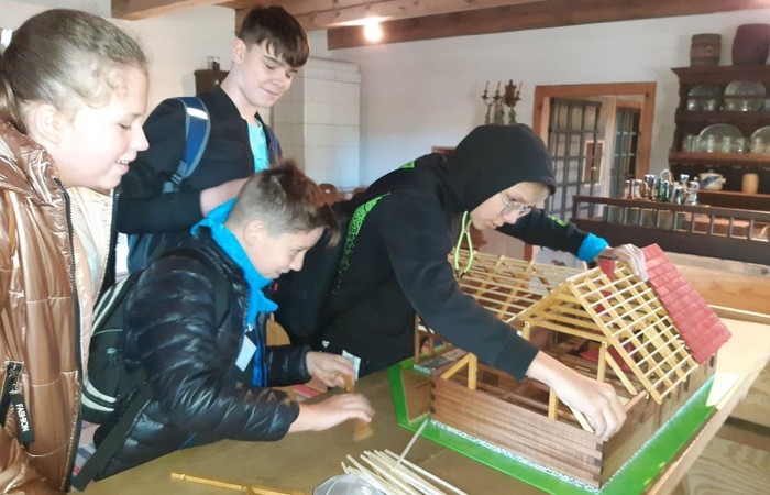 Uczestnicy projektu (19 osób z Francji, 17 z Portugalii i 25 osób z Polski) wyruszyli do Olsztynka. Tam w Muzeum Budownictwa Ludowego poznali piękno architektury naszego regionu i wzięli udział w warsztatach obróbki lnu. Podzieleni na cztery międzynarodowe grupy dowiedzieli się jak wiele lat temu żyli ludzie oraz jak pozyskiwali materiał z lnu. Każdy z uczestników miał okazję 