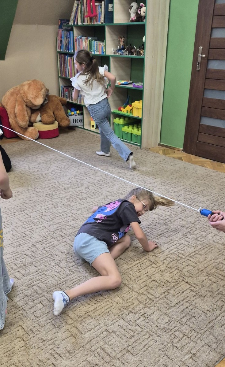 Uczniowie klasy 2B odwiedzili Bibliotekę Publiczną w Pasłęku, gdzie czekała na nich prawdziwa detektywistyczna przygoda z bohaterem znanej lektury – Detektywem Pozytywką.
Dzieci sprawdziły swoją znajomość książki, poznały ciekawostki o autorze – Grzegorzu Kasdepke, a także wzięły udział w quizach i zadaniach zespołowych. Przez chwilę mogły poczuć się jak prawdziwi detektywi – wykazując się nie tylko sprytem i spostrzegawczością, ale też świetną kondycją. Po dniu pełnym wrażeń przyszedł czas na słodki finał – wspólne wyjście na pyszne lody.
Kto wie, może wśród uczniów rosną przyszli następcy detektywa Pozytywki? Jedno jest pewne – pojawili się entuzjastyczni i zaangażowani miłośnicy książek.
