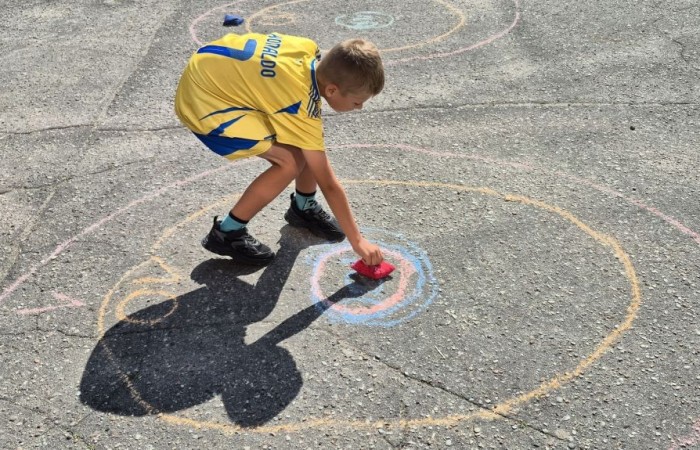 Dziś uczniowie klasy 2b wybrali się na plac przed szkołę, gdzie połączyli przyjemne z pożytecznym. Podczas zabawy w rzuty woreczkiem do celu dzieci nie tylko świetnie się bawiły, ale również ćwiczyły swoją sprawność rachunkową – dodając zdobyte przez grupy punkty.  Radość, ruch i nauka w jednym – właśnie tak lubimy się uczyć.