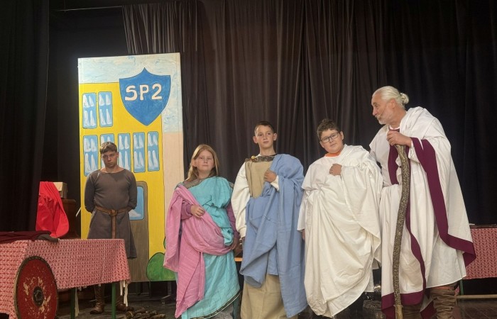 Każdego roku uczniowie naszej szkoły mają niepowtarzalną okazję wziąć udział w wyjątkowym wydarzeniu edukacyjnym - ŻYWEJ LEKCJI HISTORII, prowadzonej przez grupę rekonstrukcyjną Chorągiew Komturstwa Gniewskiego. To spotkanie, które na długo pozostaje w pamięci uczestników, łącząc wiedzę historyczną z emocjami, ruchem i bezpośrednim kontaktem z przeszłością.
W tym roku tematyka spotkań została zrealizowana na dwóch poziomach wiekowych:
Klasy 4-6: Świat starożytnych Greków i Rzymian
Uczniowie klas młodszych przenieśli się do czasów starożytności - epoki potężnych cywilizacji, mitologii, igrzysk olimpijskich i legionów rzymskich. Dzięki strojom z epoki, realistycznym rekwizytom i barwnym opowieściom rekonstruktorów, dzieci mogły poczuć atmosferę antycznego świata. Dowiedzieli się, jak wyglądało życie codzienne Greków i Rzymian, jakie były zwyczaje wojenne, a nawet jak wyglądały ćwiczenia wojskowe legionistów. Zajęcia - prowadzone w formie interaktywnej - dały uczniom możliwość przymierzenia elementów uzbrojenia oraz wzięcia udziału w krótkich pokazach.
Klasy 7-8: Długi wiek XIX
Starsze klasy uczestniczyły w lekcji poświęconej Długiemu wiekowi XIX, czyli okresowi, który ukształtował współczesny świat. Rekonstruktorzy przybliżyli wydarzenia związane z rewolucjami, walką o niepodległość, przemianami społecznymi i narodzinami nowoczesnych idei. Szczególną uwagę poświęcono wydarzeniom ważnym dla Polski - rozbiorom, powstaniom narodowym i postaciom kluczowym dla naszej historii. Uczniowie mogli zobaczyć repliki broni, a także stroje z XIX wieku. Dla wielu była to okazja do poznania historii w sposób bardziej angażujący niż podręcznik - przez opowieści, prezentacje multimedialne i inscenizacje.
Żywa lekcja historii to nie tylko atrakcja, ale przede wszystkim cenna forma nauki. Bezpośredni kontakt z pasjonatami historii oraz aktywne uczestnictwo w przedsięwzięciu sprawia, że uczniowie lepiej zapamiętują materiał, rozbudzają swoją ciekawość i rozwijają szacunek do dziedzictwa kulturowego.