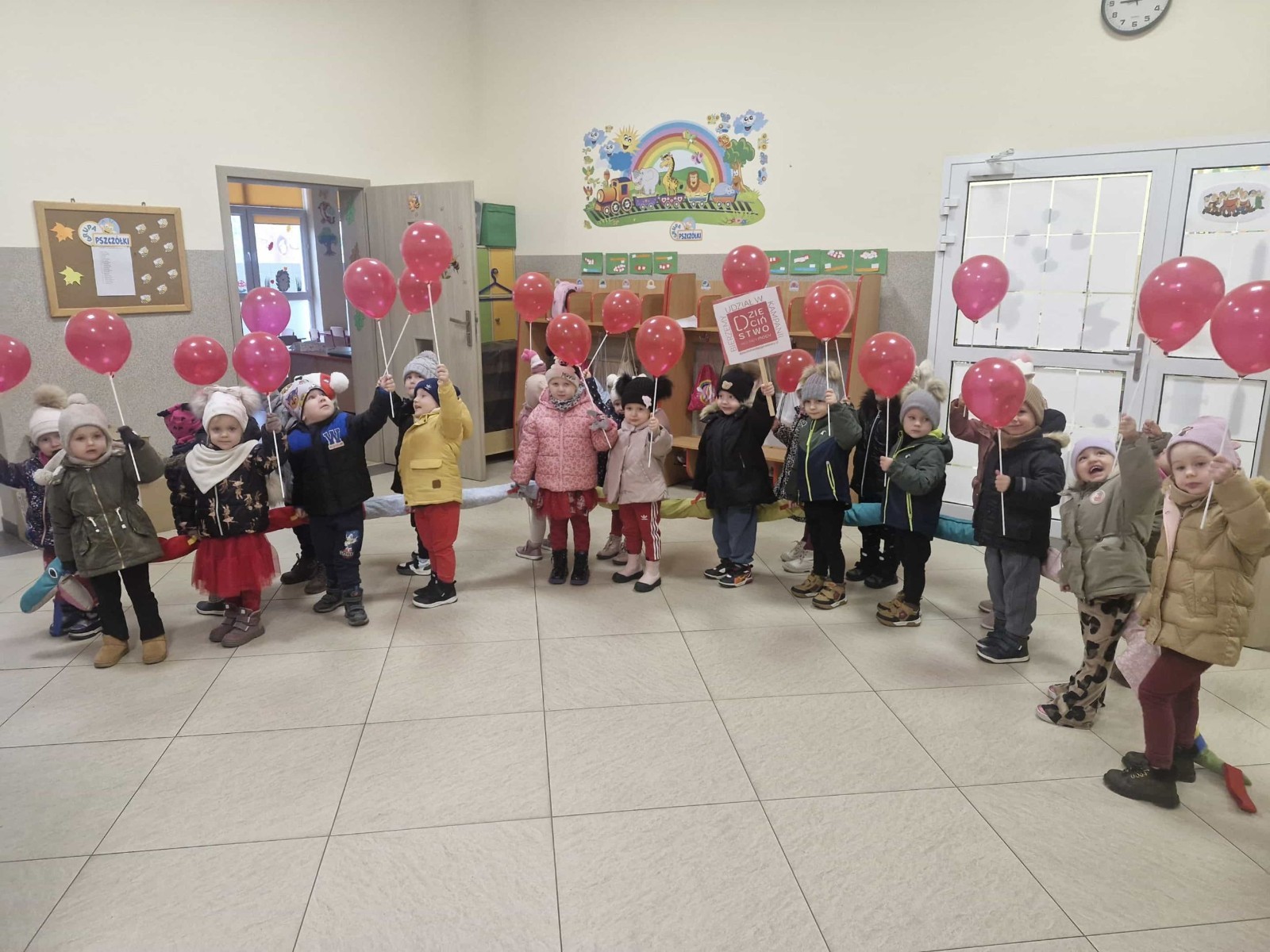 W środę 17.11.2025 nasza szkoła zorganizowała wyjątkowe wydarzenie, które było zaczątkiem podsumowania kampanii „Dzieciństwo bez Przemocy”. Dzień rozpoczął się od radosnego marszu, w którym dzieci grup przedszkolnych z wychowawczyniami oraz uczniowie wraz z nauczycielami przeszli ulicami naszego miasta. Podczas tego wydarzenia dzieci rozdawały mieszkańcom kolorowe maskotki, promując ideę bezpiecznego i szczęśliwego dzieciństwa.
Ważnym punktem dnia było spotkanie w Urzędzie Miasta z panią burmistrz, która serdecznie przyjęła naszych reprezentantów. Rozmowy dotyczyły dalszych działań na rzecz dzieci oraz wspierania inicjatyw mających na celu eliminację przemocy wśród najmłodszych.